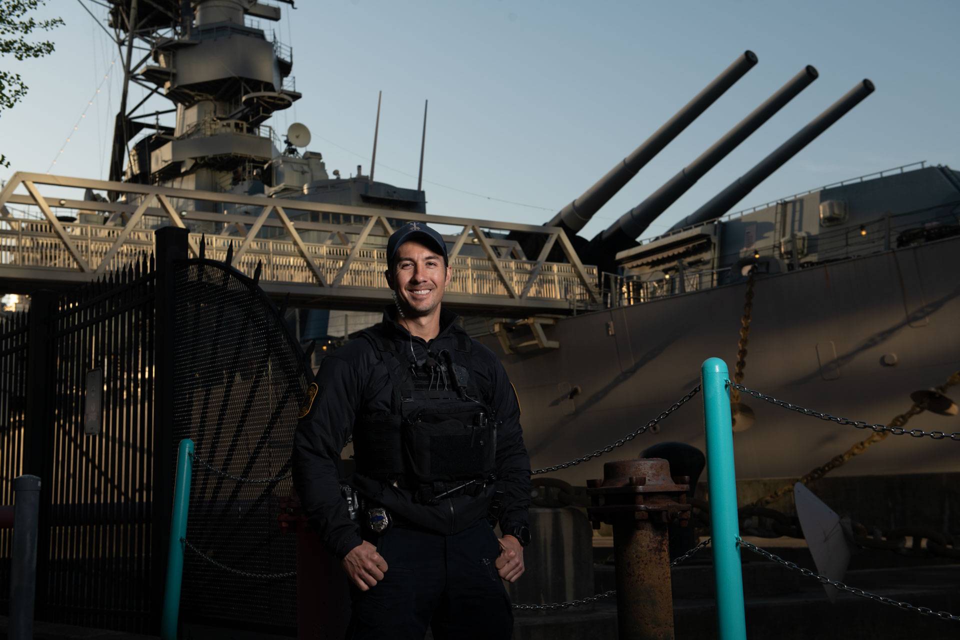 Police Officer in front of Naval ship